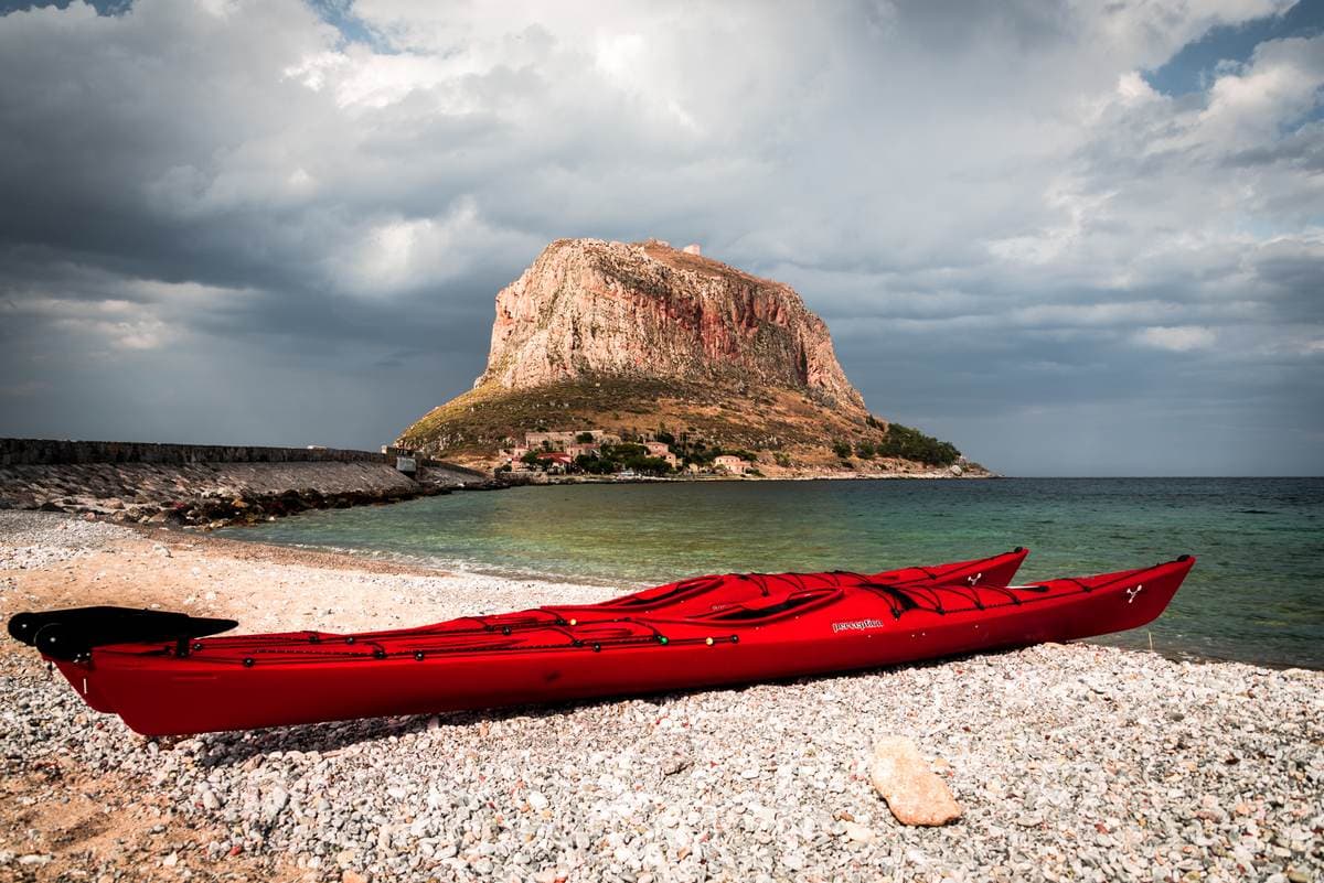 Red kayaks on the beach ready for a Sea Kayaking Monemvasia adventure