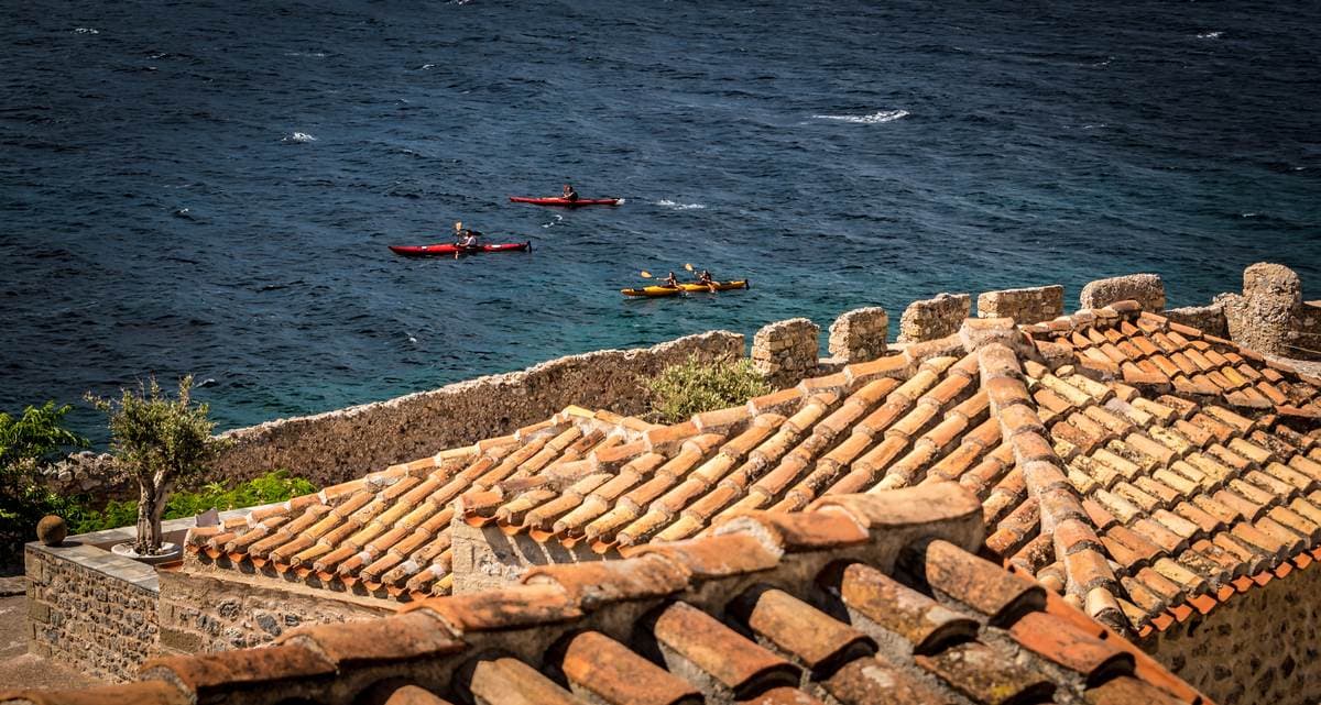 View of the rugged cliffs and rooftops of the town during a Sea Kayaking Monemvasia trip