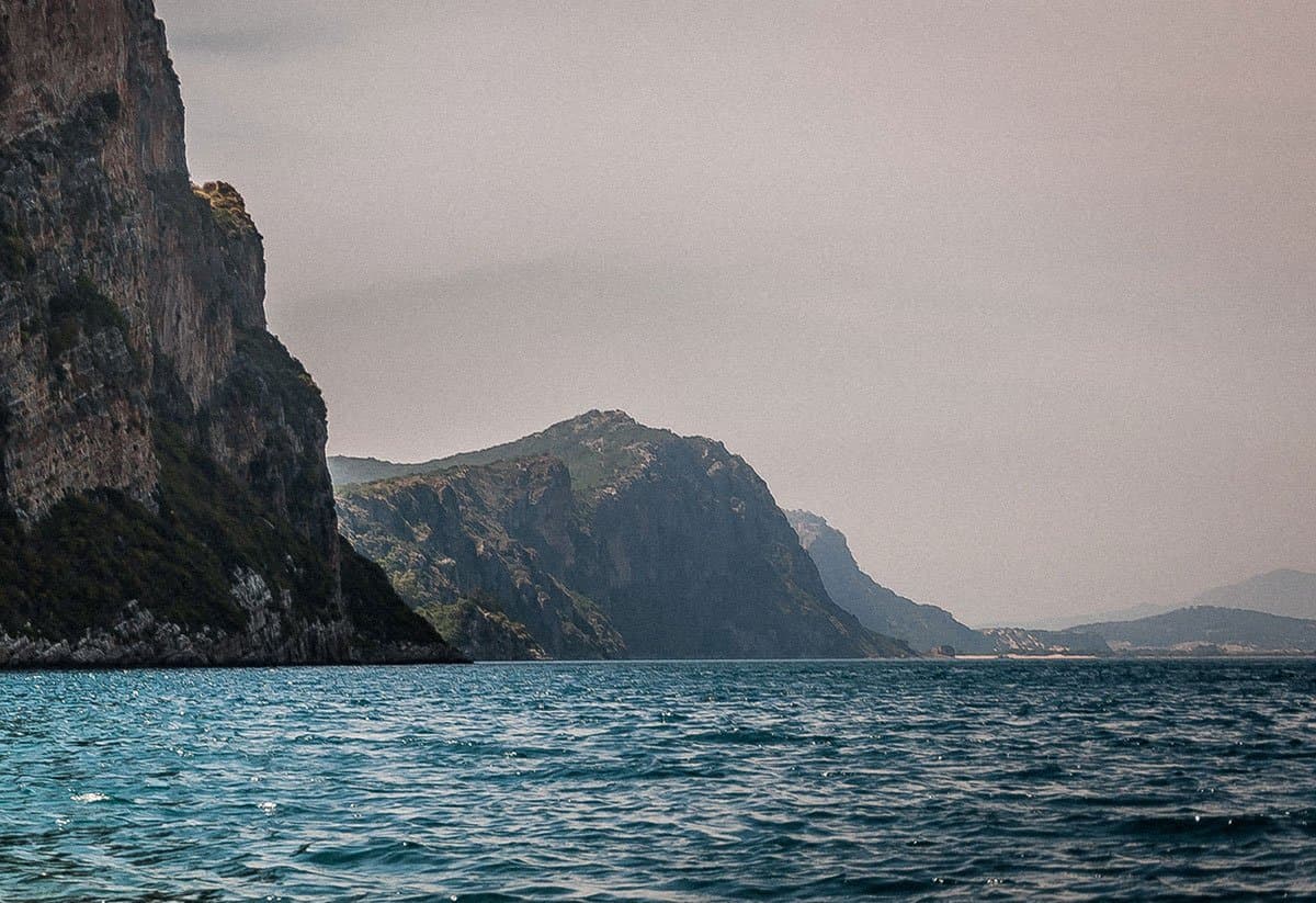 Dramatic view of the rugged cliffs and distant mountains surrounding Navarino Bay.