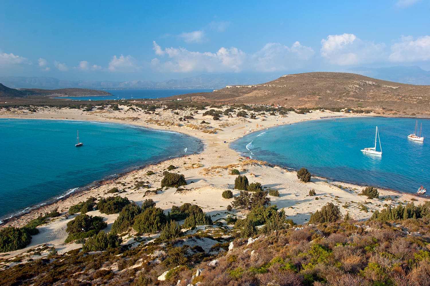 Simos beach with twin turquoise bays, dunes and sailboats on Elafonisos island