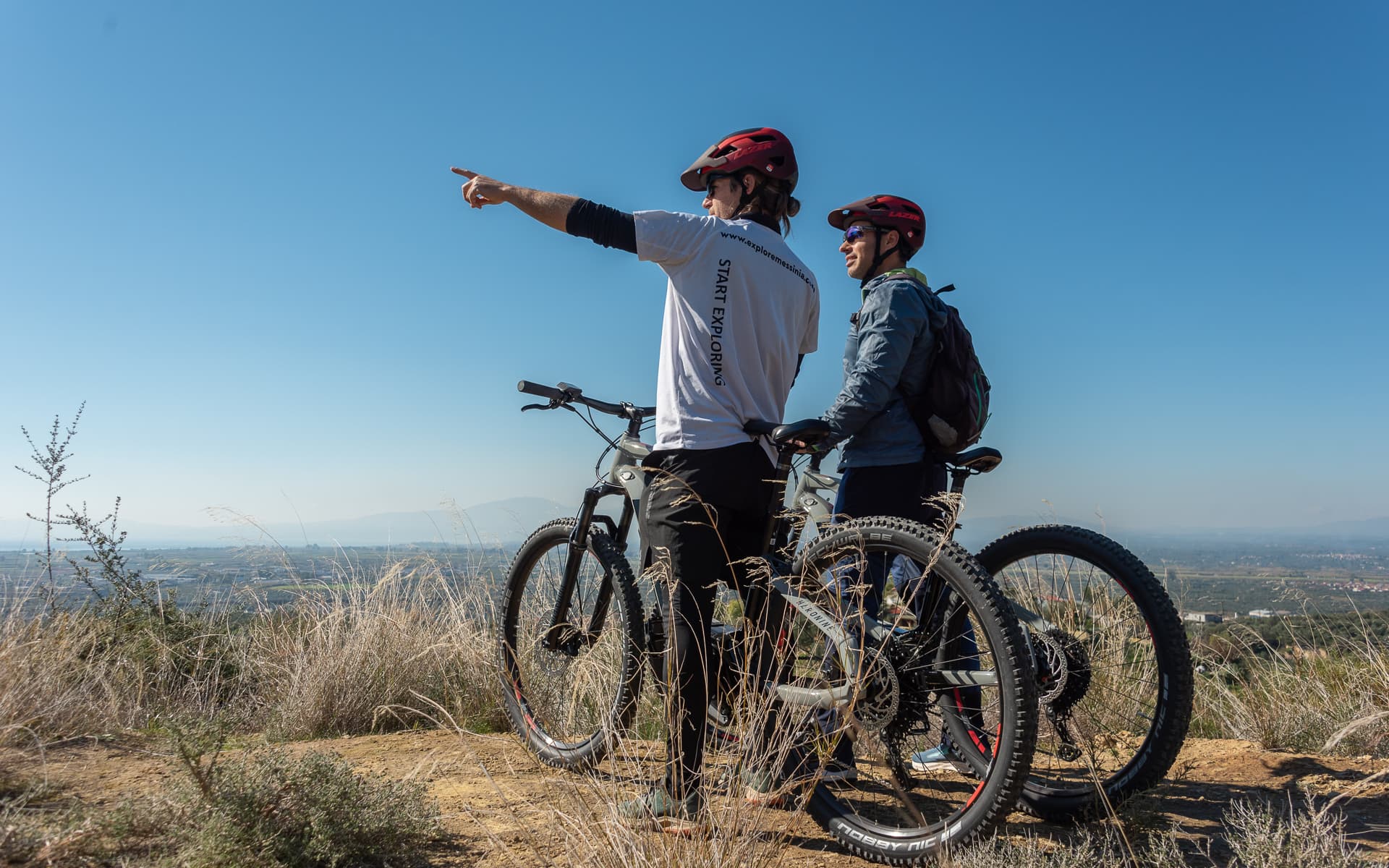 Cyclists enjoying the panoramic view of the olive groves during a Kalamata Olive Routes E-Bike Tour