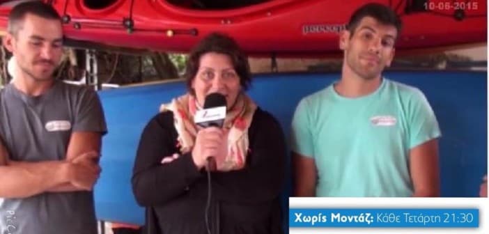 Woman with a microphone interviewed beside red kayaks, flanked by two young men, for a TV segment