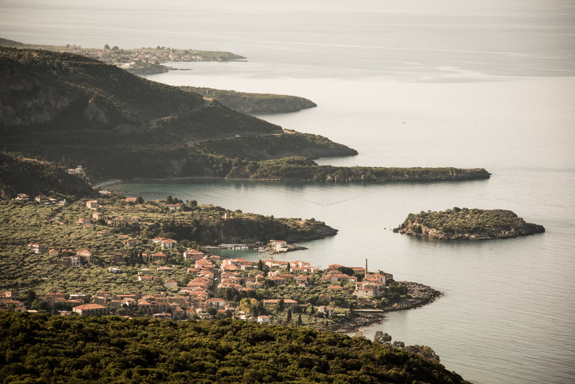 Elevated view over Kardamyli village, olive groves and rocky islets along the Mani coastline
