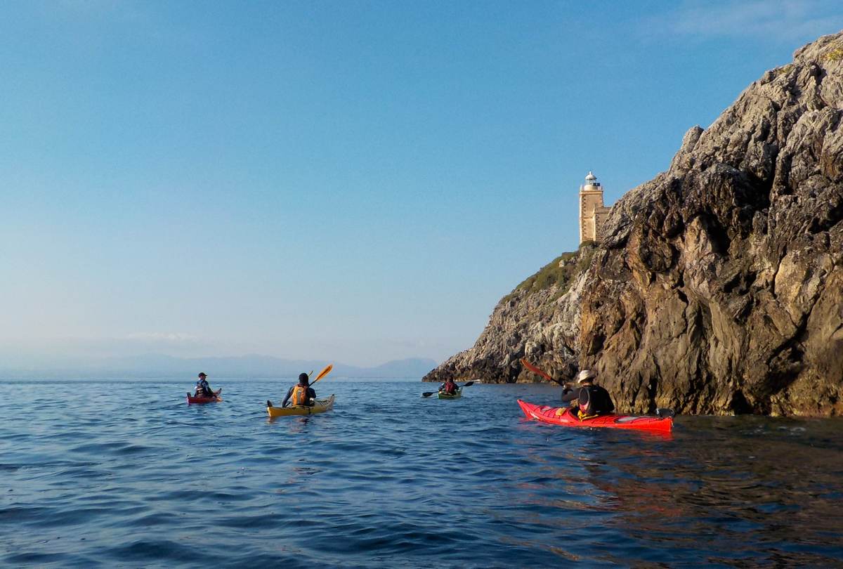 Sea kayakers paddling past the Kitries lighthouse on the Messinian coast
