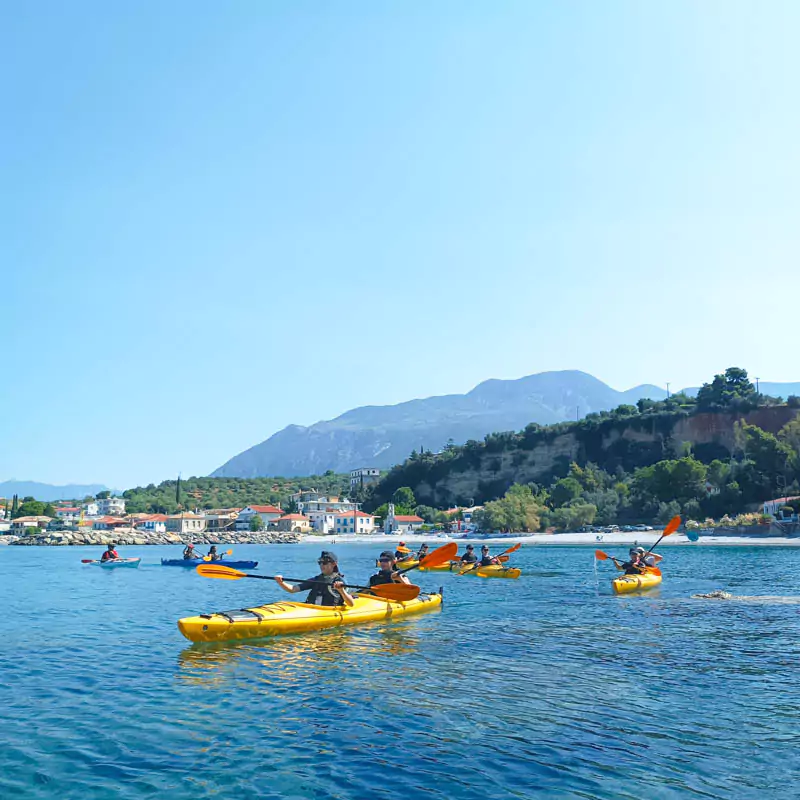 Explore Messinia-A group paddling in sea kayaks near kalamata visiting small villages and beaches.
