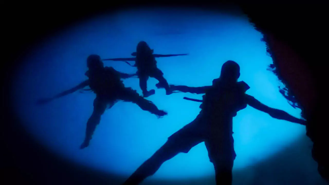 Explore Messinia-Floating inside the Blue Cave of Kardamyli, creating a magical and serene atmosphere. Explore Messinia-Silhouettes of kayakers floating inside the Blue Cave of Kardamyli, surrounded by a glowing blue water background, creating a magical and serene atmosphere.