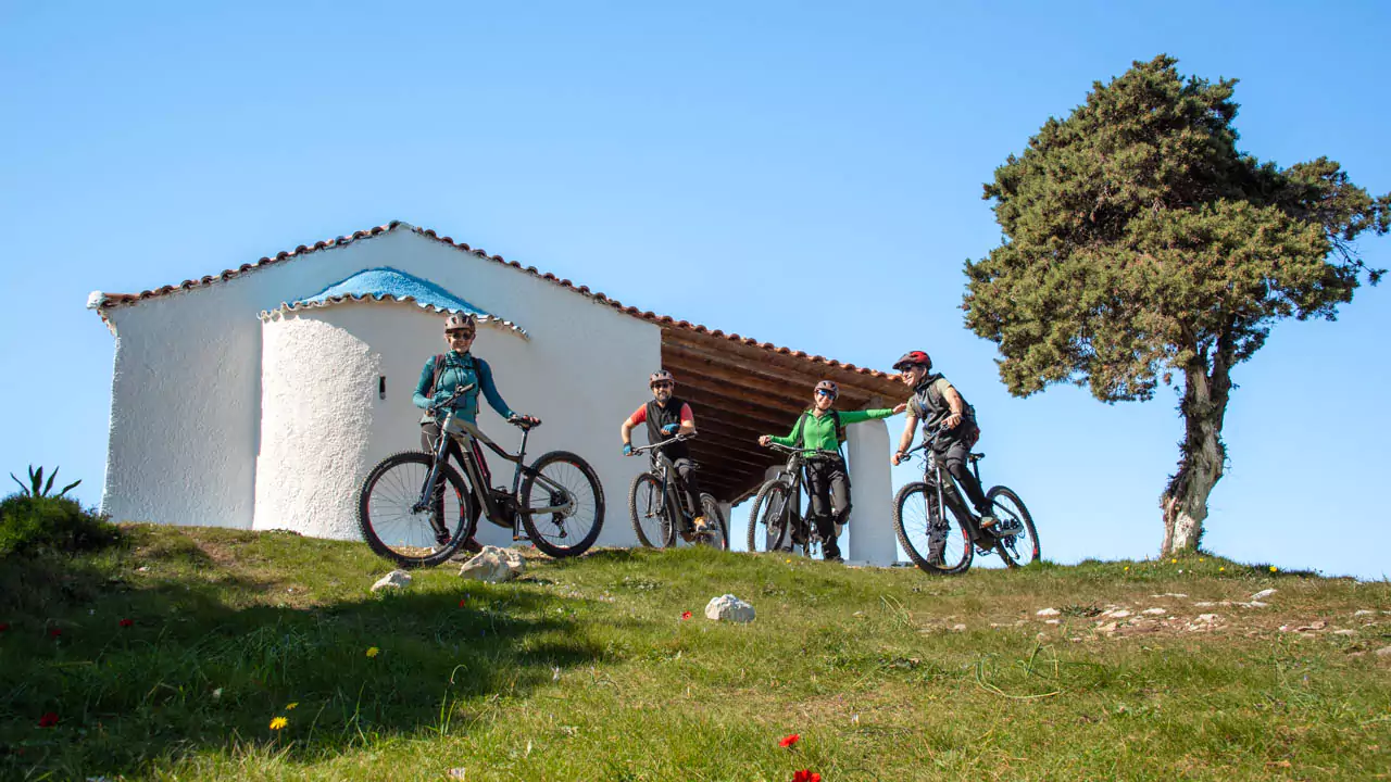 Explore Messinia-Joy fills the air as cyclists gather at Prophet Elias Church, surrounded by blooming spring flowers and panoramic views of Navarino Bay. Explore Messinia-Joy fills the air as cyclists gather at Prophet Elias Church, surrounded by blooming spring flowers and panoramic views of Navarino Bay.