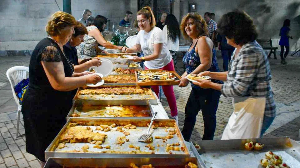 Women serving traditional artichoke dishes Women serving traditional artichoke dishes at the Artichoke Festival in Mikromani, Messinia.