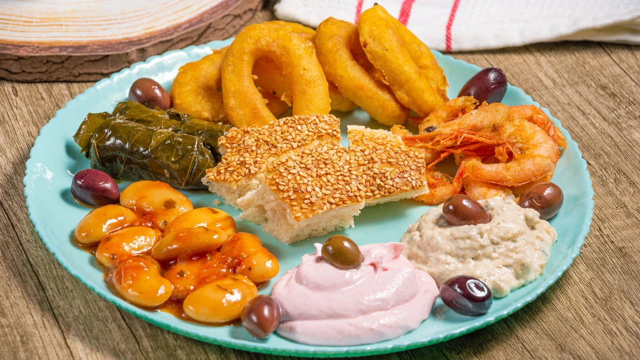 A vibrant Clean Monday lent plate A vibrant Clean Monday lent plate with taramosalata, grape leaves, shrimps, and sesame bread, a Greek fasting tradition.