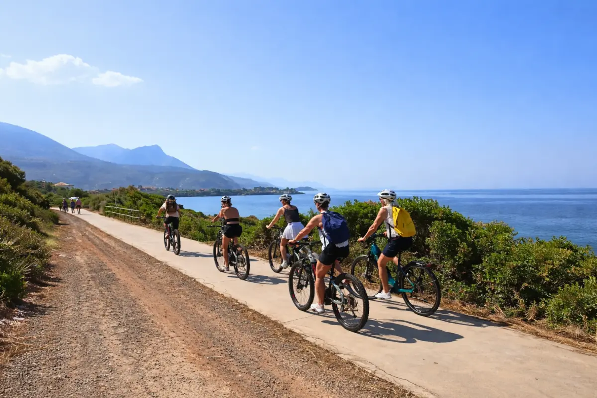 Travelers on a Mani coastal e-bike tour riding along the Mediterranean sea.
